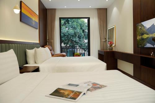 a hotel room with two beds and a window at Blubiz Hotel 9 in Hanoi