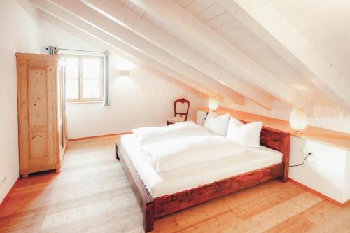a bedroom with a large bed in a attic at Luna Blanca - Apartment 3 in Schwangau