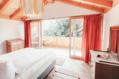 a bedroom with a bed and a large window at Luna Blanca Chalet in Schwangau