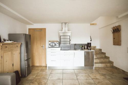 a kitchen with a refrigerator and a counter top at Luna Mia 1 Chalet in Schwangau