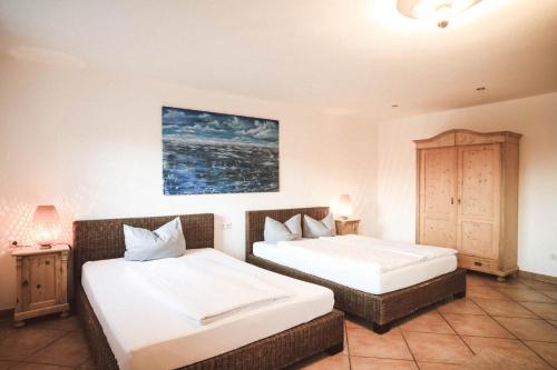 a bedroom with two beds and a cabinet at Luna Mia Apartment 2 in Schwangau