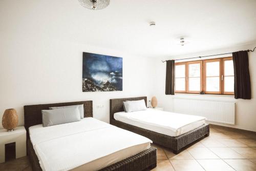 a bedroom with two beds and a window at Luna Mia Apartment 3 in Schwangau