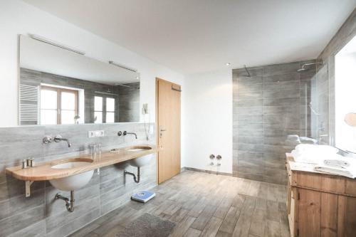 a bathroom with a sink and a large mirror at Luna Mia Apartment 3 in Schwangau