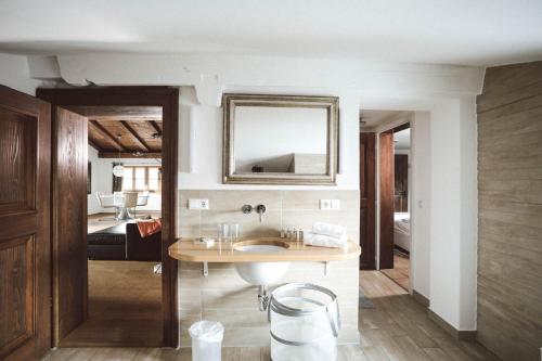 a bathroom with a sink and a mirror on the wall at Luna Mia Apartment 4 in Schwangau