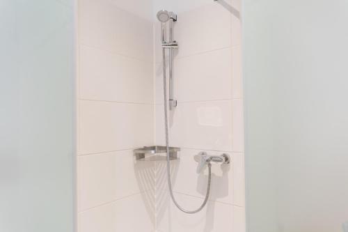 a shower with a shower head in a bathroom at Hopfenalm in Ilmmünster