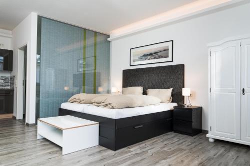 a bedroom with a bed and a glass wall at Black & White in Ilmmünster