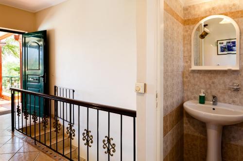 a bathroom with a sink and a mirror at Dukes Poolside Houses in Paralio Astros