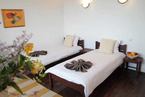two beds in a room with towels on them at Арт комплекс Горски дом - Трявна in Tryavna