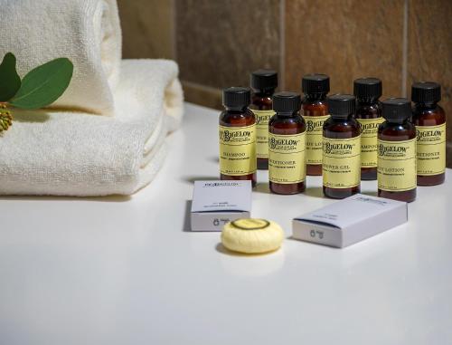 a group of four bottles of essential oils on a table at Artagonist Art Hotel in Vilnius