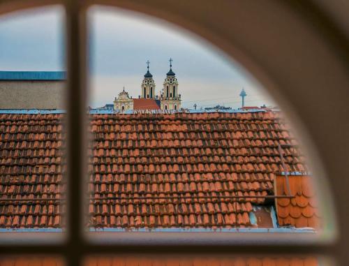 a view of a building through a window at Artagonist Art Hotel in Vilnius