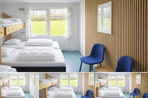 a bedroom with two beds and blue chairs at Danhostel Aalborg in Aalborg