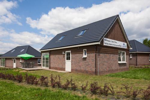 a house with solar panels on top of it at Camping 2000 in Januv Dul