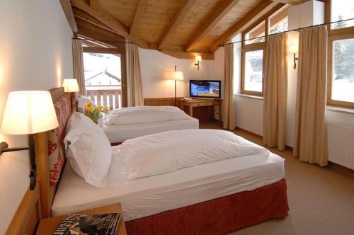 En eller flere senge i et værelse på Chalet Panorama