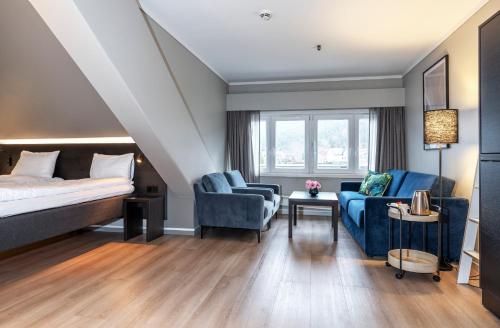 a hotel room with a bed and two chairs at Thon Hotel Baronen in Ålesund