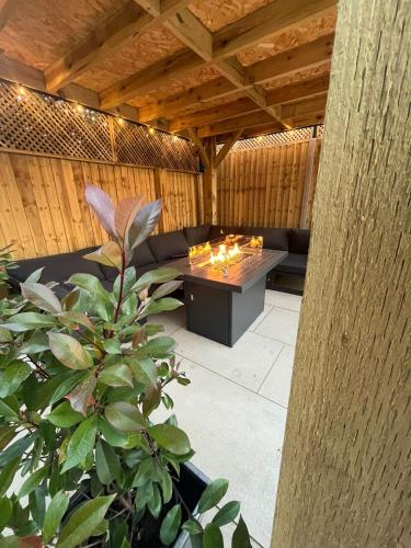 a patio with a couch and a table with candles at Sunset Retreat in Three Legged Cross