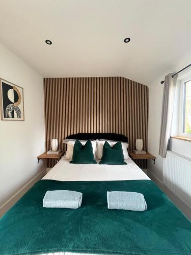 a bedroom with a large bed with two pillows at Sunset Retreat in Three Legged Cross