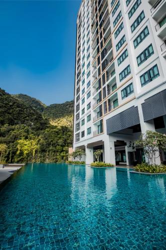 a swimming pool in front of a building at Sunway Onsen Suite in Tambun