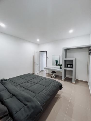 a bedroom with a large bed and a desk at L.C. Apartments in Lamai