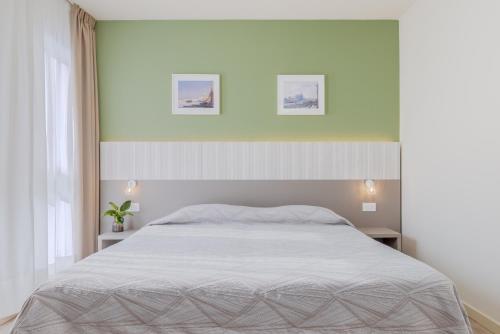 a bedroom with a bed and two pictures on the wall at Hotel Palladio in Malcontenta