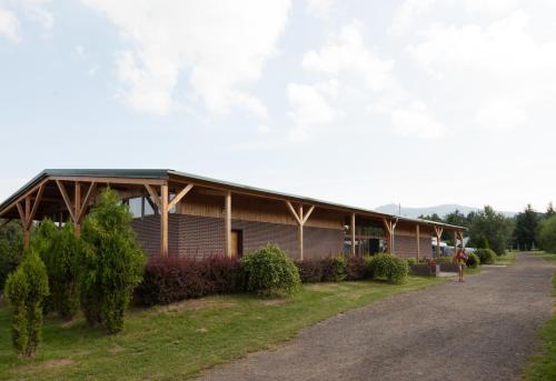 a building on a road next to a street at Camping 2000 in Januv Dul
