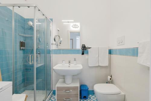 a bathroom with a sink and a toilet and a shower at Orizzonte Blu apartment - Macari Bay in Macari