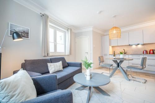 a living room with a couch and a table at Villa Seedüwel - App C01 in Ahlbeck