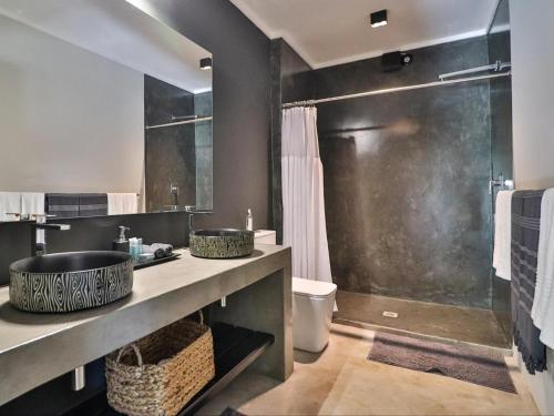 a bathroom with two sinks and a shower at Akasha by Kruger Nights in Marloth Park