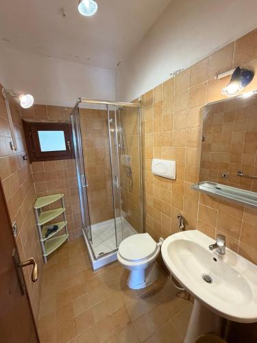 a bathroom with a shower and a toilet and a sink at Bilocali Ibiscus - 700mt dalla spiaggia in Porto Ottiolu