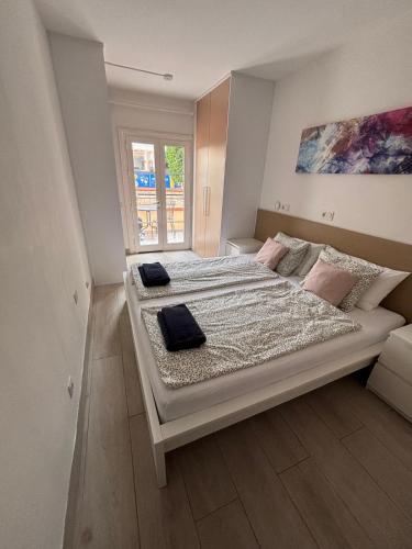 a bedroom with a large bed with two pillows on it at Costa Adeje Fañabé Beach Apartment in Adeje