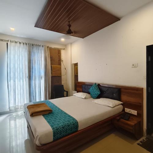 a bedroom with a large bed with blue pillows at SIYA International Lodging And Boarding in Bhiwandi