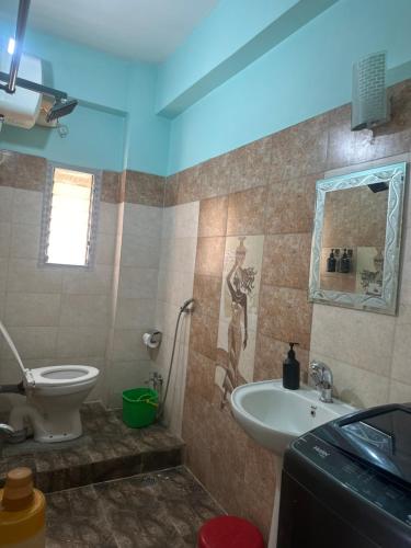 a bathroom with a toilet and a sink at J kutir in Siliguri