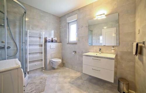 a bathroom with a toilet and a sink and a shower at Vila Giulietta in Kaštela