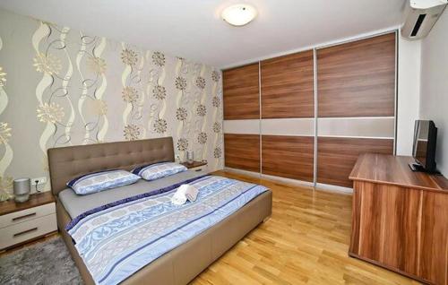 a bedroom with a bed and a television in it at Vila Giulietta in Kaštela