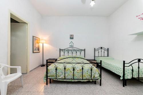a bedroom with two beds in a room at La Dimora del Centro - San Foca in San Foca