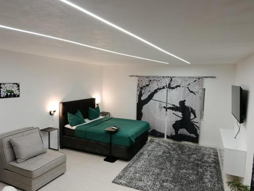 a bedroom with a bed and a chair and a television at Apartment Bogunovic in Bar