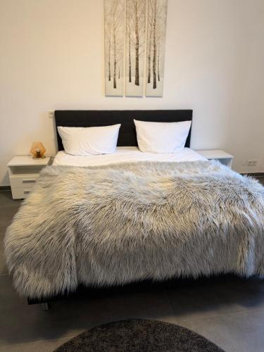 a bedroom with a bed with a faux fur blanket at Deck in Cuxhaven