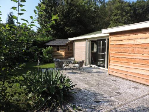 a patio with a table and a building at Bungalow Veluwemeer in Ermelo
