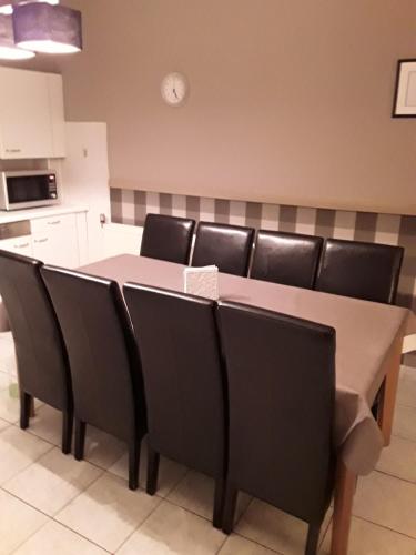 a dining room table with black chairs in a kitchen at Wenceslas Cobergher III in Bertem
