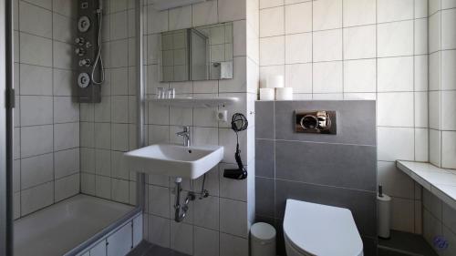 a small bathroom with a sink and a toilet at Hotel Sofia in Bad Wildungen