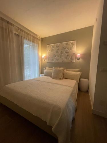 a bedroom with a large bed and a window at Guest house Festinalente in Montegrotto Terme