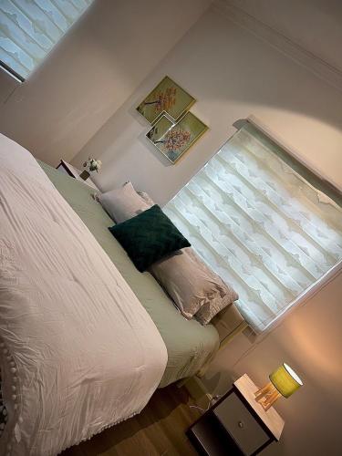 a bedroom with a bed and a window at Imaani Homes - 2A at JAK Royale in Apenkwa