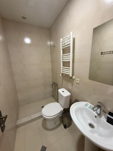 a bathroom with a toilet and a sink at Hotel Blue sky in Tbilisi City