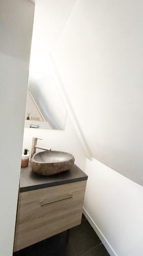 a bathroom with a sink on top of a dresser at RR4 - Penthouse in Antwerp