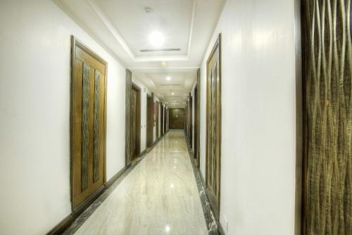 an empty corridor of a building with wooden doors at Western Court Panchkula in Chandīgarh