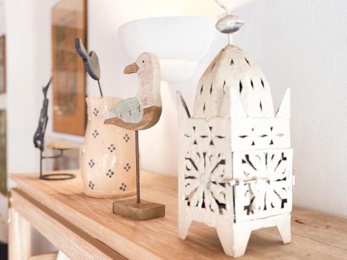 a table with a bird house and a lamp at Casa dell'Artista - HelloElba in Portoferraio