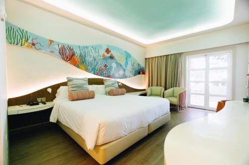 a hotel room with a bed and a fish mural at Hotel LIVVO Puerto de Mogán in Puerto de Mogán