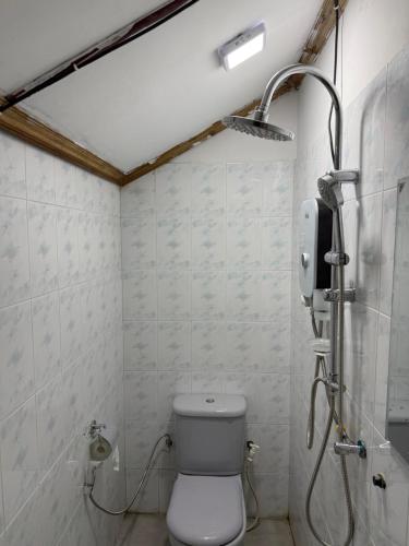 a bathroom with a toilet and a shower at The Layover Hostel in Katunayaka