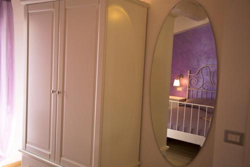 a bedroom with a mirror and a bed in a room at La Terrazza del Conero La Ginestra in Sirolo