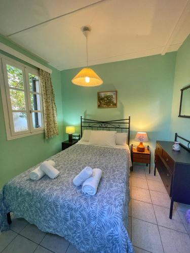 a bedroom with a bed with two pillows on it at Eleni's Cottage in Fiskardo