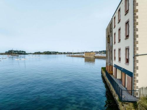 a view of a river between two buildings at ILE CEZON - Duplex de luxe avec magnifique vue mer in Landéda